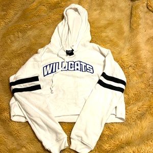 Small white this sweatshirt with blue wildcats logo and black stripes on arms
